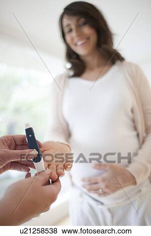 Stock Photo - Blood glucose test in pregnancy. Fotosearch