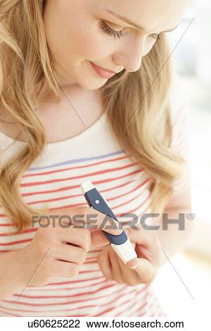 Stock Image - Blood glucose test. Fotosearch