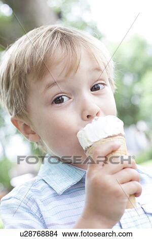 Boy eating an ice cream View Large Photo Image Picture - Boy eating an ice cream. Fotosearch