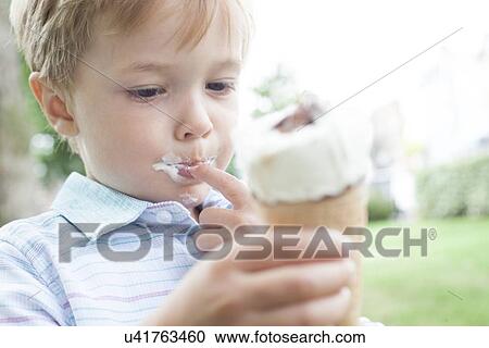 Boy eating an ice cream View Large Photo Image Stock Image - Boy eating an ice cream. Fotosearch