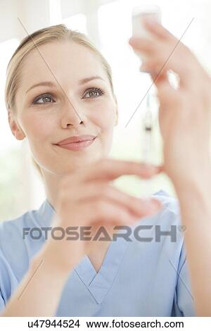 Picture - Doctor preparing injection. Fotosearch