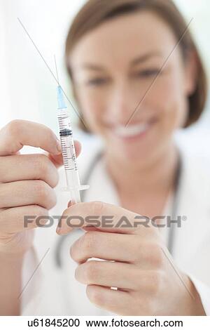 Doctor preparing injection View Large Photo Image Stock Image - Doctor preparing injection. Fotosearch