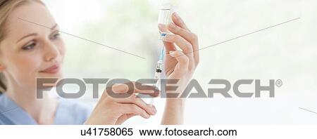 Doctor preparing injection View Large Photo Image Stock Photography - Doctor preparing injection. Fotosearch