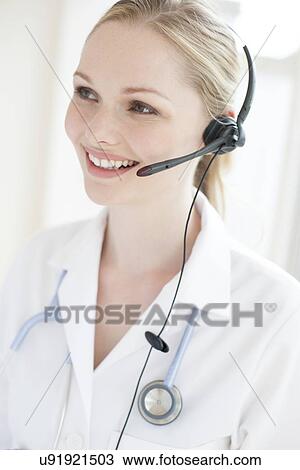 Stock Image - Doctor using a headset. Fotosearch
