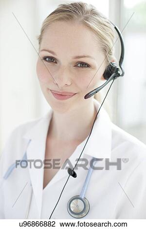 Stock Image - Doctor using a headset. Fotosearch