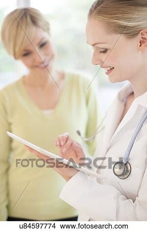Picture - Doctor using a tablet computer. Fotosearch