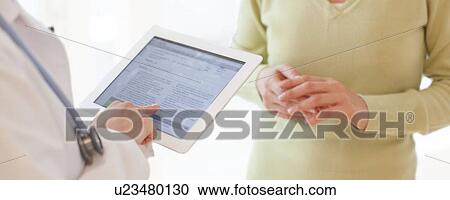 Doctor using a tablet computer View Large Photo Image Stock Image - Doctor using a tablet computer. Fotosearch