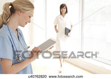 Stock Image - Doctor using a tablet computer. Fotosearch