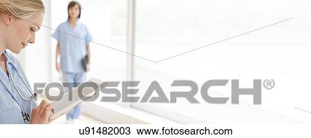 Doctor using a tablet computer View Large Photo Image Stock Image - Doctor using a tablet computer. Fotosearch