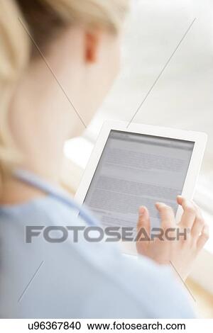 Stock Image - Doctor using a tablet computer. Fotosearch