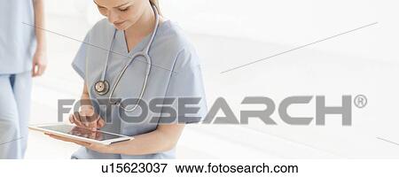 Stock Photo - Doctor using a tablet computer. Fotosearch