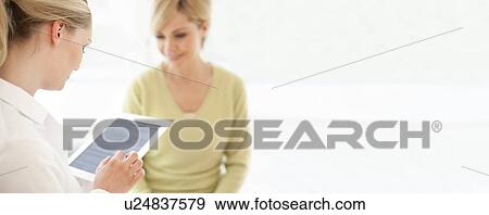 Doctor using a tablet computer View Large Photo Image Stock Photo - Doctor using a tablet computer. Fotosearch