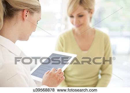 Stock Photo - Doctor using a tablet computer. Fotosearch