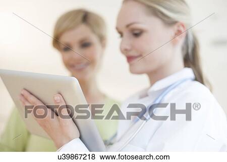Doctor using a tablet computer View Large Photo Image Stock Photo - Doctor using a tablet computer. Fotosearch