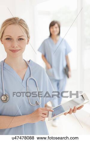 Doctor using a tablet computer View Large Photo Image Stock Photo - Doctor using a tablet computer. Fotosearch