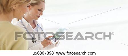 Doctor using a tablet computer View Large Photo Image Stock Photo - Doctor using a tablet computer. Fotosearch