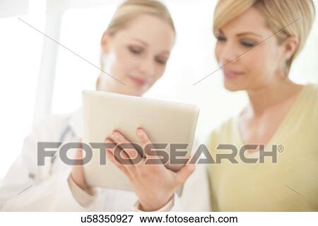 Stock Photo - Doctor using a tablet computer. Fotosearch
