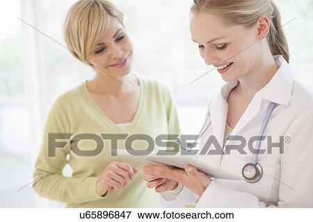 Doctor using a tablet computer View Large Photo Image Stock Photo - Doctor using a tablet computer. Fotosearch