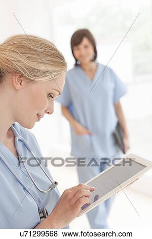 Stock Photo - Doctor using a tablet computer. Fotosearch