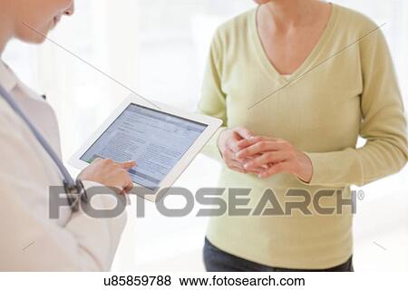 Stock Photo - Doctor using a tablet computer. Fotosearch