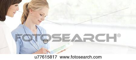 Stock Photo - Doctors using a tablet computer. Fotosearch
