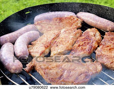 Stock Image - Meats on a barbecue. Fotosearch