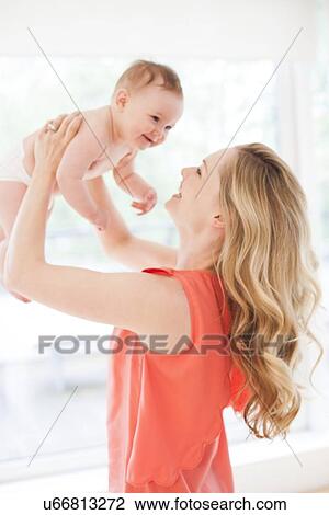 Stock Image - Mother and baby daughter. Fotosearch