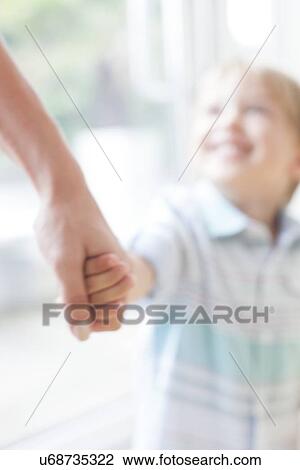 Mother and son holding hands View Large Photo Image Stock Image - Mother and son holding hands. Fotosearch