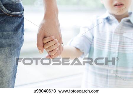 Mother and son holding hands View Large Photo Image Stock Image - Mother and son holding hands. Fotosearch