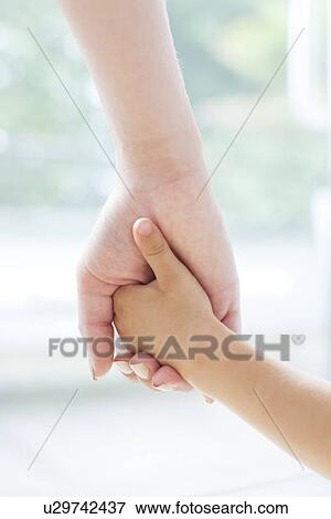 Mother and son holding hands View Large Photo Image Stock Photo - Mother and son holding hands. Fotosearch