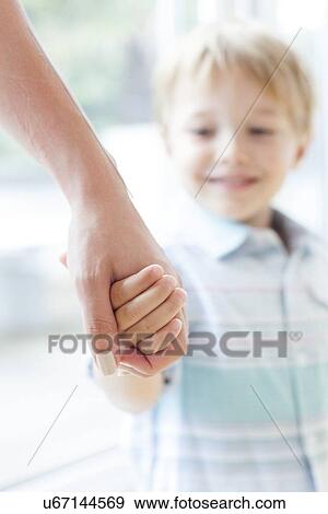 Mother and son holding hands View Large Photo Image Stock Photo - Mother and son holding hands. Fotosearch