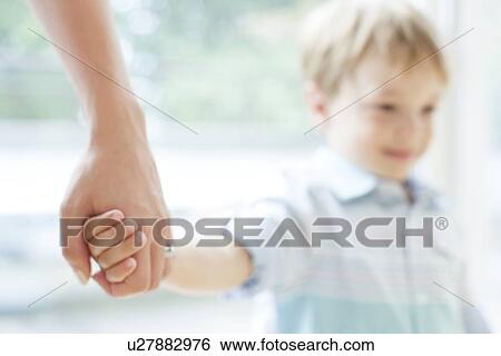 Mother and son holding hands View Large Photo Image Stock Photograph - Mother and son holding hands. Fotosearch