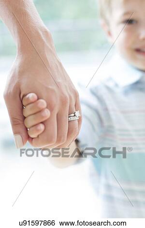 Stock Photograph - Mother and son holding hands. Fotosearch