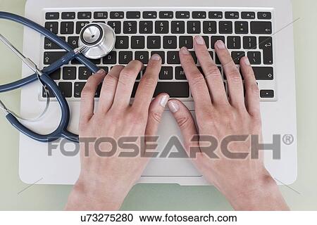 Nurse using a laptop computer View Large Photo Image Stock Image - Nurse using a laptop computer. Fotosearch