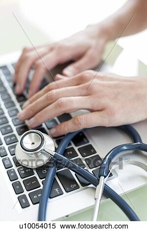 Nurse using a laptop computer View Large Photo Image Stock Photography - Nurse using a laptop computer. Fotosearch