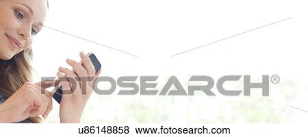 Stock Photo - Nurse using a smart phone. Fotosearch