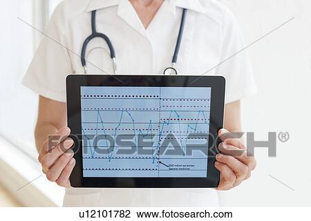 Nurse using a tablet computer View Large Photo Image Stock Image - Nurse using a tablet computer. Fotosearch
