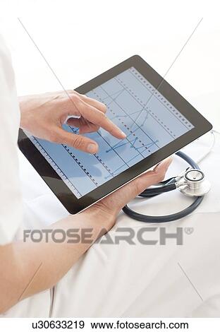 Stock Photo - Nurse using a tablet computer. Fotosearch