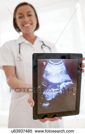Stock Photography - Nurse with baby scan. Fotosearch