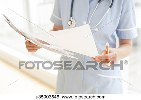 Stock Photography - Nurse with paperwork. Fotosearch