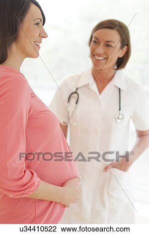Stock Image - Pregnant woman and nurse. Fotosearch
