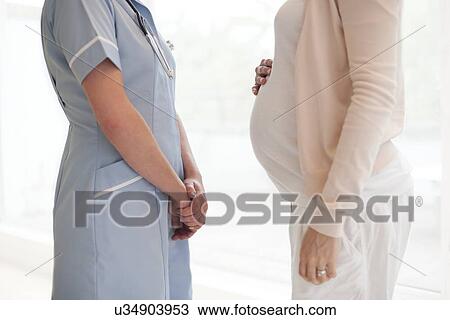 Stock Image - Pregnant woman and nurse. Fotosearch