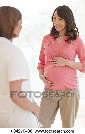 Pregnant woman and nurse View Large Photo Image Stock Photo - Pregnant woman and nurse. Fotosearch