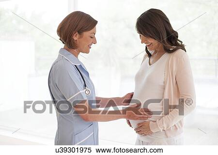 Pregnant woman and nurse View Large Photo Image Stock Photography - Pregnant woman and nurse. Fotosearch