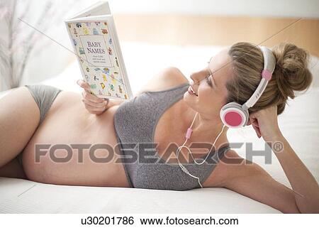 Pregnant woman choosing baby names View Large Photo Image Stock Photograph - Pregnant woman choosing baby names. Fotosearch