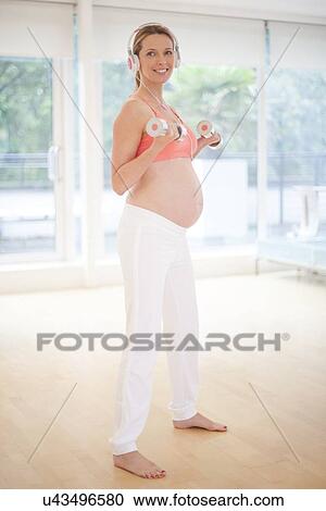 Pregnant woman exercising View Large Photo Image Stock Image - Pregnant woman exercising. Fotosearch