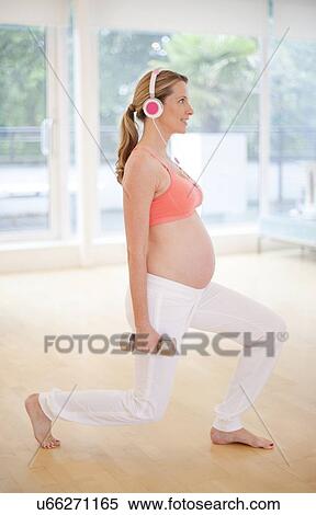 Pregnant woman exercising View Large Photo Image Stock Photography - Pregnant woman exercising. Fotosearch