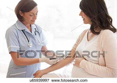 Pregnant woman having blood taken View Large Photo Image Stock Photo - Pregnant woman having blood taken. Fotosearch