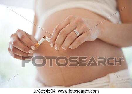 Pregnant woman quitting smoking View Large Photo Image Picture - Pregnant woman quitting smoking. Fotosearch