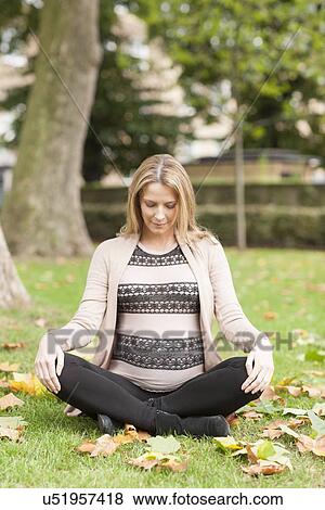 Pregnant woman sitting in park View Large Photo Image Stock Photo - Pregnant woman sitting in park. Fotosearch
